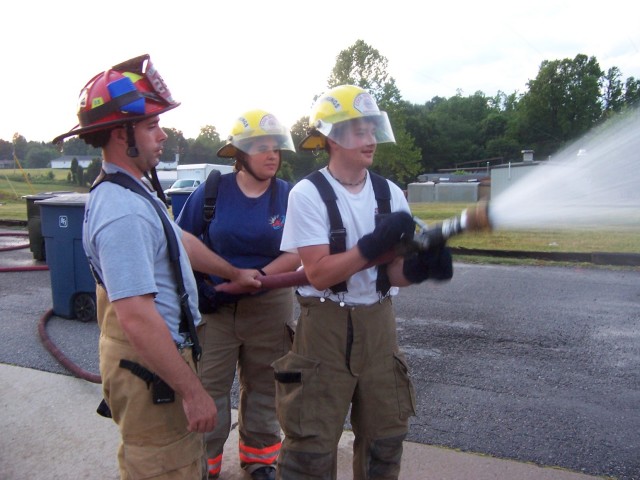 Captain Ray Elmore training with Junior Firefighters Cristan Elmore & DJ Summers.